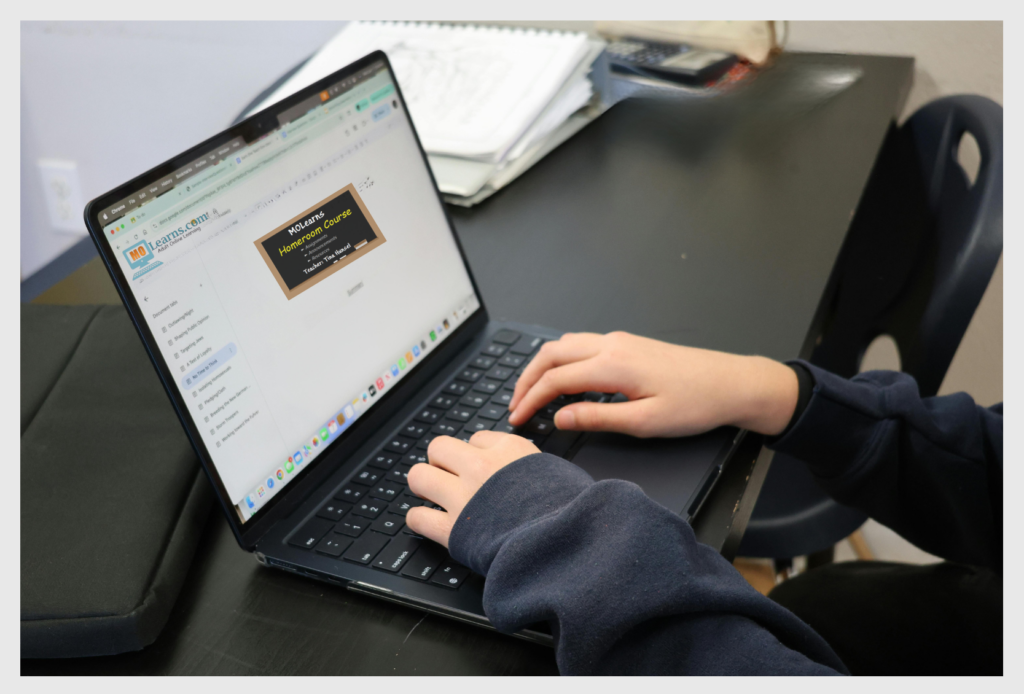 Candid photo of a person using a laptop computer.